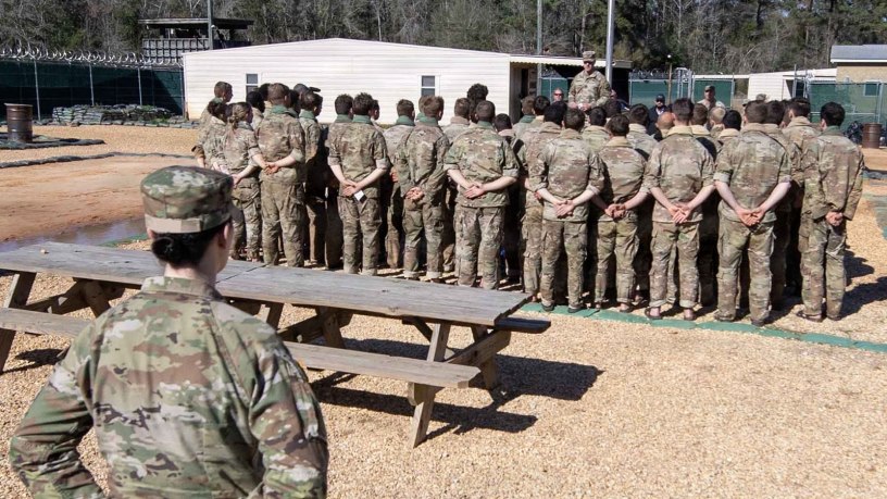 Students at the Army's Survival, Evasion, Resistance, and Escape course at Fort Rucker complete their culminating exercise, and gather to salute the American flag as they begin the repatriation process during the recent large-scale reintegration exercise in conjunction with US Army South, the Joint Personnel Recovery Agency, the U.S. Air Force, the U.S. Navy, and U.S. Army Special Operations Command from March 14-18, 2026. (Contributed Photo)