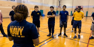 Logistics Specialist 1st Class Shadijah Copeland, left, a recruiter assigned to Navy Talent Acquisition Group Pittsburgh (NTAG Pittsburgh), speaks to future Sailors during a Delayed Entry Program meeting, Blair Regional YMCA, March 12, 2026. NTAG Pittsburgh, part of Navy Recruiting Command, recruits the next generation of Navy Sailors throughout areas in Pennsylvania, New York, West Virginia, and Maryland. (U.S. Navy photo by Mass Communication Specialist 1st Class Robert Stamer.)