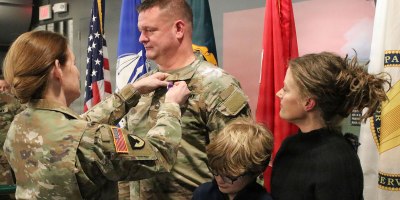 Maj. Gen. Stephanie Howard, director, Defense Logistics Agency Joint Reserve Force, pins the Purple Heart Medal on Master Sgt. Anthony Patera, contracting officer, during a ceremony held March 13 at the Rock Island Arsenal Museum, Illinois.