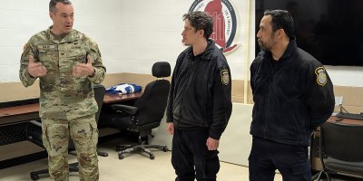 Col. Jason Adler, Fort Drum garrison commander, presents Civilian Service Commendation Medals to Matthew Bailey and Nelson Cuevas, Department of the Army security guards, on March 19, 2026, for their decisive actions during an incident in early March at Cerjan Gate. The combined efforts of Directorate of Emergency Services personnel and military police ensured a quick and professional response that prioritized the safety of the Fort Drum community. (Photo by Mike Strasser, Fort Drum Garrison Public Affairs)