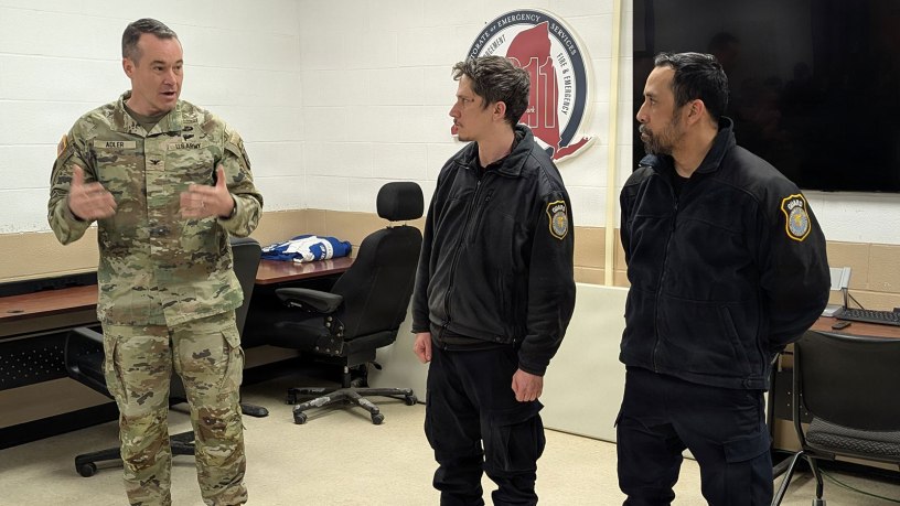 Col. Jason Adler, Fort Drum garrison commander, presents Civilian Service Commendation Medals to Matthew Bailey and Nelson Cuevas, Department of the Army security guards, on March 19, 2026, for their decisive actions during an incident in early March at Cerjan Gate. The combined efforts of Directorate of Emergency Services personnel and military police ensured a quick and professional response that prioritized the safety of the Fort Drum community. (Photo by Mike Strasser, Fort Drum Garrison Public Affairs)