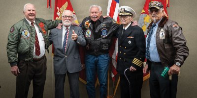 Brothers of Maj. Everette McPherson and Marines who served alongside him pose for a photo before a posthumous Distinguished Flying Cross ceremony at Marine Support Facility New Orleans, March 18, 2026. The Distinguished Flying Cross is awarded to those who have displayed single acts of heroism or extraordinary achievement while participating in aerial flight. Maj. McPherson, a fighter jet pilot, posthumously received the award for sacrificing his life during the Vietnam War in an attempt to save the life of his co-pilot. (U.S. Marine Corps photo by Lance Cpl. Claire Cheney)