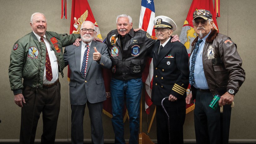 Brothers of Maj. Everette McPherson and Marines who served alongside him pose for a photo before a posthumous Distinguished Flying Cross ceremony at Marine Support Facility New Orleans, March 18, 2026. The Distinguished Flying Cross is awarded to those who have displayed single acts of heroism or extraordinary achievement while participating in aerial flight. Maj. McPherson, a fighter jet pilot, posthumously received the award for sacrificing his life during the Vietnam War in an attempt to save the life of his co-pilot. (U.S. Marine Corps photo by Lance Cpl. Claire Cheney)