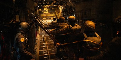 U.S. Air National Guard Tech. Sgt. Jacob Thomas, a loadmaster with the 103d Airlift Wing, assists paratroopers from the 160th Special Operations Aviation Regiment as they prepare to jump from a C-130 Hercules during Joint Airborne/Air Transportability Training at Base Lewis-McChord, Wash., March 25, 2026. The 103d and 160th executed multiple heavy equipment and personnel airdrops throughout the week, reinforcing precision delivery capabilities and joint mission execution. (Photo by U.S. Air National Guard Captain Jennifer Kaprielian)