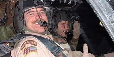 U.S. Army Chief Warrant Officer 4 Brent South offers a thumbs up from seat of a Kiowa Warrior OH-58D in Taji, Iraq, June 12, 2004. South survived a crash that destroyed a helicopter, and nearly took his life. (Courtesy photo)