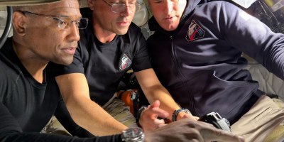 NPS alumni U.S. Navy Capt. Victor Glover, spacecraft pilot, and mission commander retired U.S. Navy Capt. Reid Wiseman, along with mission specialist Jeremy Hansen of the Canadian Space Agency prepare for their journey around the far side of the Moon by configuring their camera equipment shortly before beginning their lunar flyby observations. (Credit NASA)