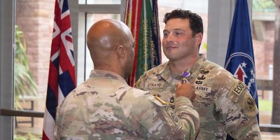 U.S. Army Sergeant First Class Ryan Stratis, U.S. Army Pacific, Explosive Ordinance Disposal (EOD) Plans and analysis NCO, Is pinned on the Purple Heart medal by General Ronald P. Clark, USARPAC, Commanding General, at Fort Shafter, Hawaii, Apr. 10, 2026. Stratis was awarded the purple heart for valor during his deployment to Afghanistan in 2019. (U.S. Army photo by PV2 Parker Phillips)