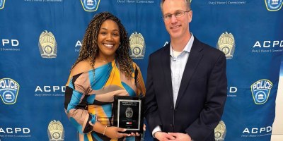 Army Lt. Col. Kevin Kirchgraber, director of Andrew Rader Army Health Clinic, stands with JonNeka Charles-Sein, a licensed practical nurse at the clinic, following her recognition with the Arlington County Police Department's 2025 Departmental Award for Life-Saving Award April 10, 2026, in Arlington, Virginia.