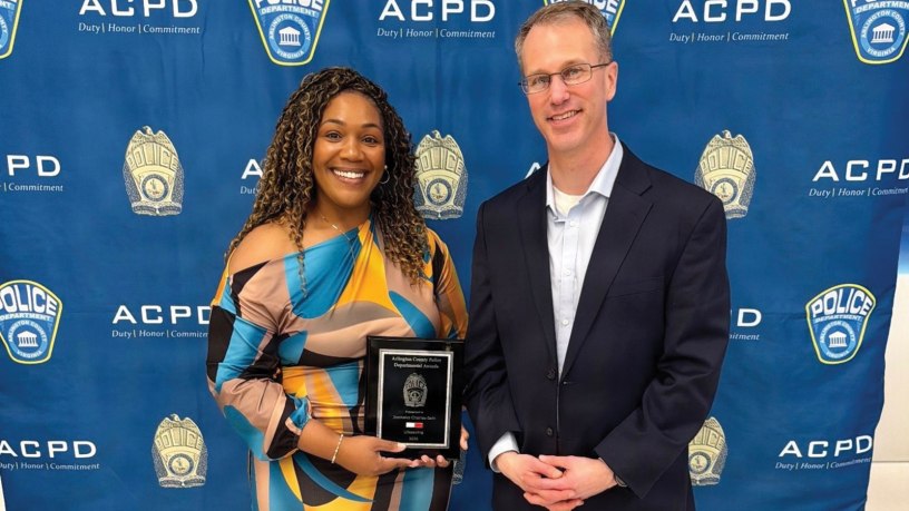 Army Lt. Col. Kevin Kirchgraber, director of Andrew Rader Army Health Clinic, stands with JonNeka Charles-Sein, a licensed practical nurse at the clinic, following her recognition with the Arlington County Police Department's 2025 Departmental Award for Life-Saving Award April 10, 2026, in Arlington, Virginia.