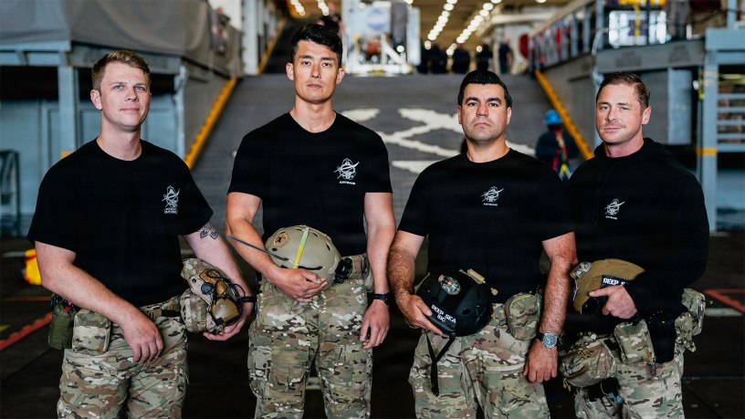 From left, Hospital Corpsman 1st Class Steve Kapala, Lt. Cmdr. Jesse Wang, Chief Hospital Corpsman Vlad Link, and Senior Chief Hospital Corspman Laddy Aldridge, the U.S. Navy dive medical team with Explosive Ordnance Disposal Group 1, pose for a group photo ahead of Artemis II recovery operations while underway on Amphibious transport dock ship USS John P. Murtha (LPD 26) in the Pacific Ocean, April 9, 2026.