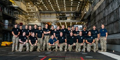 U.S. Navy divers and explosive ordnance disposal technicians pose for a group photo ahead of Artemis II recovery operations while underway on Amphibious transport dock ship USS John P. Murtha (LPD 26) in the Pacific Ocean, April 10, 2026.