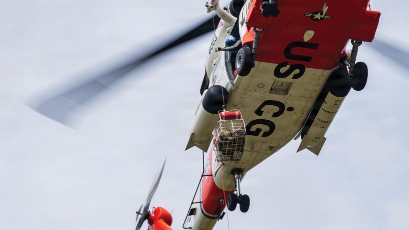 A U.S. Coast Guard Sikorsky MH-60 Jayhawk helicopter from Coast Guard Station Astoria, Oregon, conducts takeoff and hoist iteration in a hover as ground crew members, made up of Flight Medics, Search and Rescue Corpsmen, and Rescue Swimmers, train with simulated patients at the Sandy River Airport, Sandy, Oregon, on April 10, 2026.