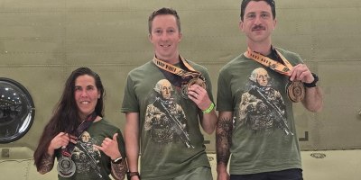 Capt. Julie Keppner, 122nd Theater Public Affairs Support Element; Maj. Brendan Thompson, Special Operations Detachment–Pacific and Capt. Eddy Allen, Headquarters and Headquarters Company, 56th Theater Information Operations Group show off their medals following the National Guard Endurance Team trials, held as part of the Nebraska DekaFit Road Show at the Nebraska Army Aviation Support Center in Grand Island, Nebraska, April 11, 2026. (Courtesy Photo)