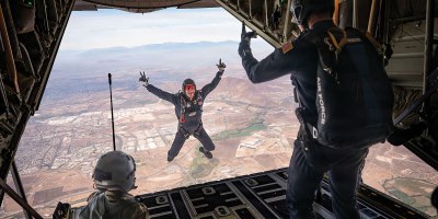A U.S. Air Force Academy Wings of Blue parachute team member exits a Texas Air National Guard C-130J Super Hercules over Santiago, Chile, during the Feria Internacional del Aire y del Espacio (FIDAE), April 11, 2026. Their participation showcased the skill and training of future Air Force leaders while strengthening connections with partner nations. (U.S. Air Force photo by Airman 1st Class Samantha Melecio)