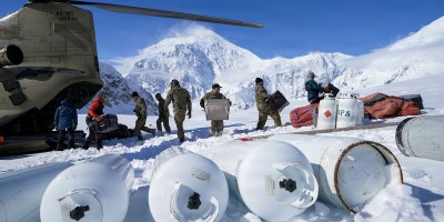 Alaska Army National Guard CH-47F Chinook aircrew members and National Park Service personnel assigned to Denali National Park and Preserve’s Denali Rescue Team offload equipment at Denali Base Camp on the Kahiltna Glacier, April 14, 2026. The crews delivered more than 5,500 pounds of cargo to support the establishment of base camp operations ahead of the climbing season on Mount McKinley. (Alaska National Guard photo by Dana Rosso)