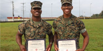 U.S. Marine Corps Lance Cpl. Karson King, left, an administrative specialist and Lance Cpl. Damian Bluntson, a supply chain specialist, both with 2nd Battalion, 7th Marines forward deployed under 4th Marine Regiment, 3rd Marine Division as part of the Unit Deployment Program, pose for a photo during an award presentation formation on Camp Schwab, Okinawa, Japan, April 15, 2026.