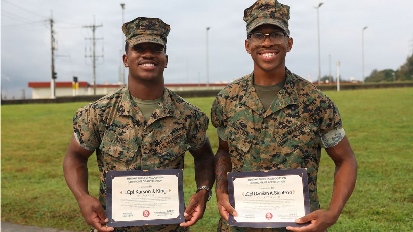U.S. Marine Corps Lance Cpl. Karson King, left, an administrative specialist and Lance Cpl. Damian Bluntson, a supply chain specialist, both with 2nd Battalion, 7th Marines forward deployed under 4th Marine Regiment, 3rd Marine Division as part of the Unit Deployment Program, pose for a photo during an award presentation formation on Camp Schwab, Okinawa, Japan, April 15, 2026.