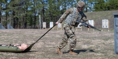U.S. Air Force Tech. Sgt. Patrick McGuiness, a fusion analyst with the 102nd Intelligence Wing, participates in the stress shoot task during the 2026 Massachusetts National Guard Best Warrior Competition at Camp Edwards, Massachusetts, April 16, 2026. During the event, competitors performed one minute of burpees before dragging a skid with a dummy to four covered positions, where they engaged targets from each point using an M4 and M17 pistol. (Air National Guard photo by Senior Airman Julia Ahaesy)