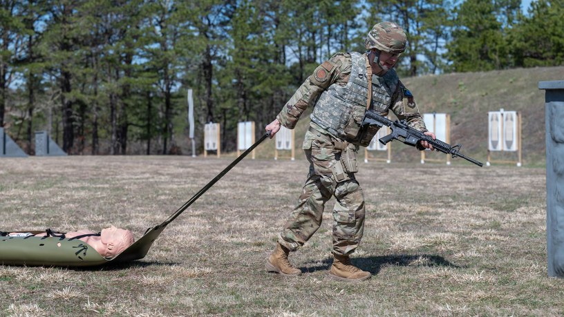 U.S. Air Force Tech. Sgt. Patrick McGuiness, a fusion analyst with the 102nd Intelligence Wing, participates in the stress shoot task during the 2026 Massachusetts National Guard Best Warrior Competition at Camp Edwards, Massachusetts, April 16, 2026. During the event, competitors performed one minute of burpees before dragging a skid with a dummy to four covered positions, where they engaged targets from each point using an M4 and M17 pistol. (Air National Guard photo by Senior Airman Julia Ahaesy)