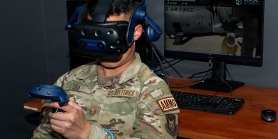 Tech. Sgt. Tou Tswj Cha, 302d Maintenance Squadron aircraft maintainer, uses hand controllers and headset to navigate around the C-130 Hercules virtually in the Extended Reality lab at Peterson Space Force Base, Colorado, April 16, 2026. Being able to practice tasks virtually has contributed to more than 19 million in cost savings by reducing wear and tear on the real world equipment components. (U.S. Air Force photo by Tech. Sgt. Kate Parker)