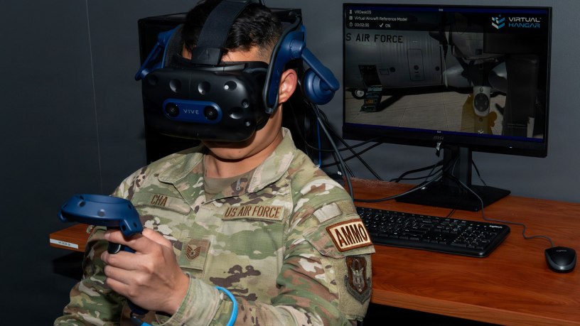 Tech. Sgt. Tou Tswj Cha, 302d Maintenance Squadron aircraft maintainer, uses hand controllers and headset to navigate around the C-130 Hercules virtually in the Extended Reality lab at Peterson Space Force Base, Colorado, April 16, 2026. Being able to practice tasks virtually has contributed to more than 19 million in cost savings by reducing wear and tear on the real world equipment components. (U.S. Air Force photo by Tech. Sgt. Kate Parker)