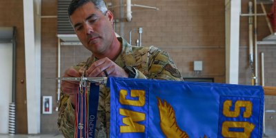 U.S. Air Force Col. Jose Cabrera, 355th Wing commander, places a new Operation Allies Refuge streamer on the 55th Rescue Squadron guidon during a Presidential Unit Citation ceremony at Davis-Monthan Air Force Base, Arizona, April 17, 2026. The campaign streamer denotes the unit’s service and battle honors earned during unconventional combat search and rescue operations in support of the final withdrawal of U.S. troops from Afghanistan, resulting in the safe evacuation of 124,000 people between July 16 and Aug. 31, 2021. (U.S. Air Force photo by Staff Sgt. Kahdija Slaughter)