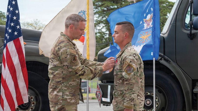 From right, U.S. Air Force Master Sgt. Charles Zingrone, 177th Fighter Wing Logistics Readiness Squadron Petroleum, Oils and Lubricants (POL) fuels management flight chief, receives a Bronze Star medal from Col. Matthew Vanderschuere, 177th Fighter Wing Mission Support Group commander, during a presentation ceremony for Zingrone at the 177th POL facility, Egg Harbor Township, New Jersey, April 17, 2026. (U.S. Air National Guard photo by Senior Airman Connor Taggart)