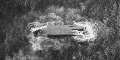A U.S. Coast Guard HC-130 Hercules airplane crew assigned to Coast Guard Air Station Barbers Point flies over an overturned vessel offshore Saipan, April 18, 2026. The Coast Guard and partners are searching for a 145-foot missing vessel, the Mariana, that experienced an engine failure April 15, 2026. (U.S. Coast Guard photo Courtesy Air Station Barbers Point)