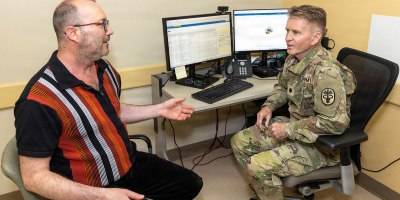 U.S. Army Lt. Col. Matthew Dugard, a primary care physician, uses ambient listening software during a patient appointment on April 20, 2026, at Walter Reed National Military Medical Center, Bethesda, Md. Walter Reed medical professionals participated in a trial to test ambient listening software. As a first-class medical care center, Walter Reed continually explores the latest technology for its providers who care for military members and their families. (DOW photo by Ann Brandstadter)