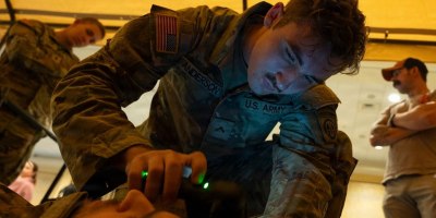 A combat medic assigned to 3rd Battalion, 319th Field Artillery Regiment, 82nd Airborne Division, operates an intercranial hemorrhage assessment device during a Soldier touchpoint event Sept. 18, 2024. Battlefield traumatic brain injury assessments and a refreshed Warfighter Brain Health initiative were focal points of discussion during the 2026 Annual Brain Health Symposium, hosted by the Traumatic Brain Injury Center of Excellence. Military medical leaders and scholars discussed a range of topics concerning brain health including the latest research across multiple areas of military medical study. (Photo by T. T. Parish)