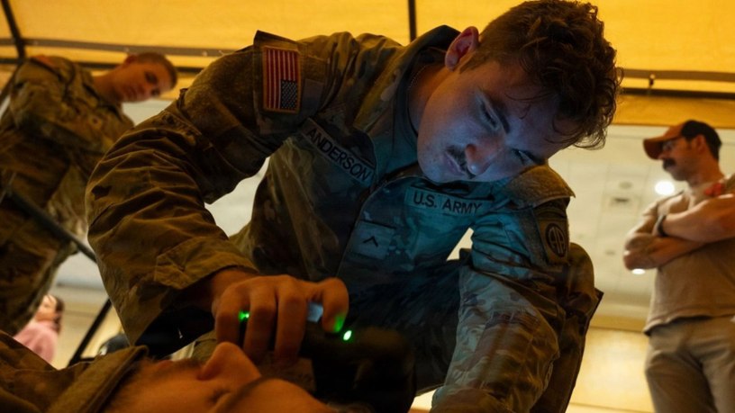 A combat medic assigned to 3rd Battalion, 319th Field Artillery Regiment, 82nd Airborne Division, operates an intercranial hemorrhage assessment device during a Soldier touchpoint event Sept. 18, 2024. Battlefield traumatic brain injury assessments and a refreshed Warfighter Brain Health initiative were focal points of discussion during the 2026 Annual Brain Health Symposium, hosted by the Traumatic Brain Injury Center of Excellence. Military medical leaders and scholars discussed a range of topics concerning brain health including the latest research across multiple areas of military medical study. (Photo by T. T. Parish)