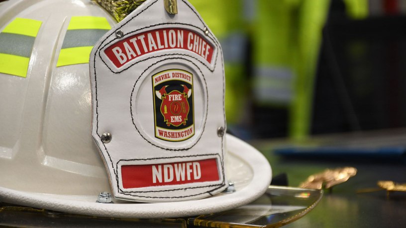 A battalion chief helmet sits on the awards table at the Naval Support Facility (NSF) Dahlgren Fire Station during an April 21 recognition and promotion ceremony for members of Naval District Washington (NDW) Fire and Emergency Services Dahlgren Company.