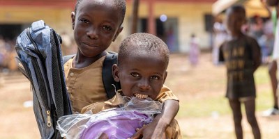 Two young boys holding their new backpacks following a school supplies donation ceremony at the Ouffoué-Diékro Primary School during exercise Flintlock 26 in Ouffoué-Diékro, Côte d’Ivoire, April 24, 2026.