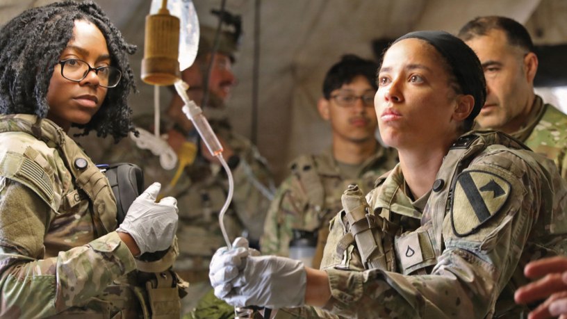 U.S. Army Private First Class Fantashia Carroll a combat medic assigned to the 215th Brigade Support Battalion, 3rd Brigade, 1st Cavalry Division, adjusts an IV on a simulated combat casualty as part of Walking Blood Bank training at Hohenfels Training Area, Germany, April 26, 2026. 3rd Brig., 1st Cavalry Division, is closing out its 9-month rotation in support of Operation Atlantic Resolve in Poland, Lithuania, and Estonia.