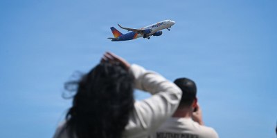 Family members watch as a plane carrying U.S. Army soldiers assigned to the 192nd Military Police Battalion depart Bradley Air National Guard Base, April 28, 2026, in support of an overseas deployment. Soldiers are deploying to an undisclosed location to assist with security and logistical operations tied to U.S. military detention missions. (U.S. Air National Guard photo by Staff Sgt. Emme Drummond)