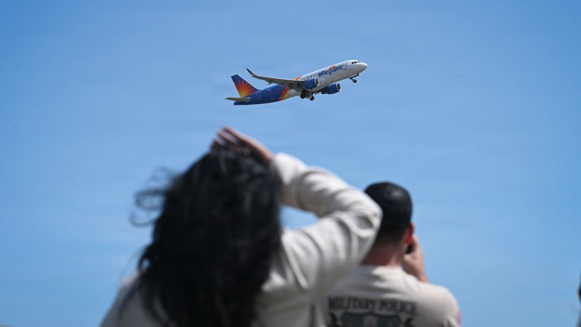 Family members watch as a plane carrying U.S. Army soldiers assigned to the 192nd Military Police Battalion depart Bradley Air National Guard Base, April 28, 2026, in support of an overseas deployment. Soldiers are deploying to an undisclosed location to assist with security and logistical operations tied to U.S. military detention missions. (U.S. Air National Guard photo by Staff Sgt. Emme Drummond)