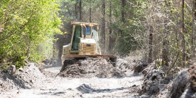 A bulldozer crew with 877th Engineer Company, 878th Engineering Battalion, 648th Maneuver Enhancement Brigade, Georgia National Guard, clears burnt brush during wildland fire suppression efforts in Pineland Georgia, April 29, 2026. The Georgia Department of Defense plays an integral role in declared emergencies by providing a versatile and ready force capable of responding to natural and manmade disasters across the United States.
