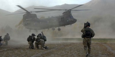 Soldiers of the joint force brace themselves against the CH-47 Chinook helicopter rotor wash at a helicopter landing zone in Zanakhan District, of Ghazni province, Afghanistan, on Oct. 31, 2009. (DoD photo by Spc. Walter Reeves, U.S. Army. (Released))