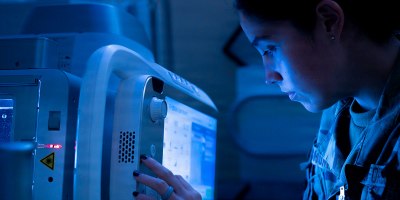 U.S. Air Force Airman 1st Class Isa Shuman, a radiology technologist assigned to the 6th Medical Group, adjusts a digital radiology machine prior to taking an X-ray. In alignment with the Military Health System Digital Transformation Strategy, the MHS focuses on education in digital health solutions and informatics to develop a technology component medical workforce — strengthening readiness across the force.
