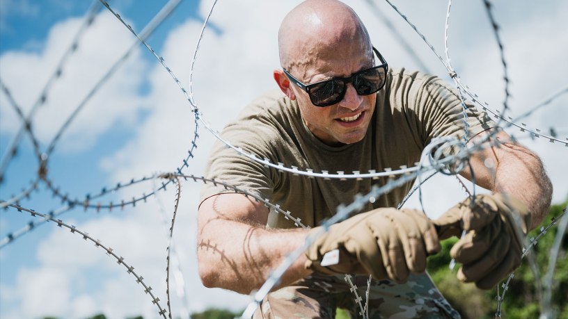 A U.S. Air Force senior enlisted leader secures concertina wire in Ceiba, Puerto Rico, Oct. 14, 2025. U.S. military forces are deployed to the Caribbean in support of the U.S. Southern Command mission, Department of War-directed operations, and the president’s priorities to disrupt illicit drug trafficking and protect the homeland. (U.S. Air Force photo by Senior Airman Katelynn Jackson)