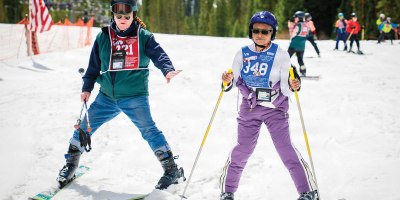 U.S. Army Veteran Suzette Pinnock skis alongside a volunteer instructor during the 40th National Disabled Veterans Winter Sports Clinic in Snowmass, Colorado, April 10, 2026. Of the 319 Veterans attending this year’s clinic, just 69 are women and only 58 served during the Gulf War era, underscoring Pinnock’s message that more Veterans should take that first effort to get out and get connected. (U.S. Department of Veterans Affairs photo by Emily Bell)