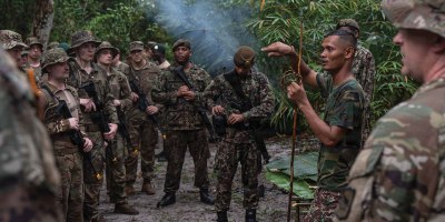 Suriname Armed Forces Sgt. First Class Alvaro Ronoreso teaches survival techniques to U.S. Soldiers and Airmen, as well as Suriname Armed Forces members, during Operation Rumble in the Jungle at Ayoko, Suriname, April 17, 2026. The austere environment survival exchange is designed to test the forces' ability to operate together in demanding jungle conditions, marking 20 years of security cooperation between the South Dakota National Guard and Suriname through the Department of War National Guard Bureau State Partnership Program. Photo by Senior Airman Kyle St. Pierre.