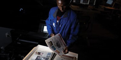 Malik Ahmad, a digital collections student assistant with the University of Nevada, Las Vegas, prepares Nellis Air Force Base newspapers for digitization at the UNLV Lied Library in Las Vegas, Nevada, April 21, 2026. The digitization project addresses the need to preserve a fragile and irreplaceable archive of newspapers, making the base’s rich history accessible to the public and future generations of Airmen. (U.S. Air Force photo by Airman 1st Class Jennifer Nesbitt)