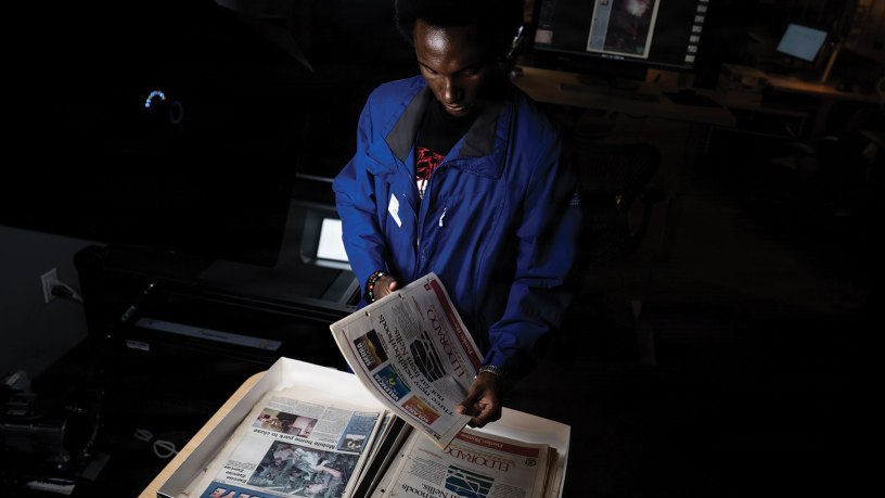 Malik Ahmad, a digital collections student assistant with the University of Nevada, Las Vegas, prepares Nellis Air Force Base newspapers for digitization at the UNLV Lied Library in Las Vegas, Nevada, April 21, 2026. The digitization project addresses the need to preserve a fragile and irreplaceable archive of newspapers, making the base’s rich history accessible to the public and future generations of Airmen. (U.S. Air Force photo by Airman 1st Class Jennifer Nesbitt)