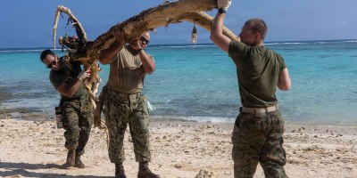 U.S. Sailors and Marines assigned to the Boxer Amphibious Ready Group (ARG) and 11th Marine Expeditionary Unit (MEU), remove debris during a beach cleanup on Ypao Beach, Guam, April 21, 2026.