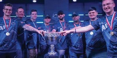 The U.S. Air Force ESports team gather around the tournament trophy after securing victory during the Armed Forces ESports competition April 25, 2026, in Philadelphia. Staff Sgt. Sheldon Cox, 32d Communications Squadron, Iowa Air National Guard, was named MVP of several rounds, leading to a U.S. Air Force victory. (Courtesy Photo)