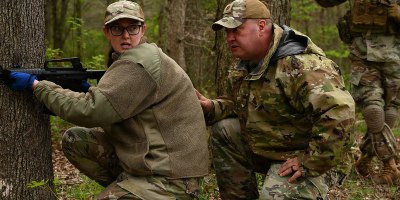 U.S. Air Force Tech. Sgt. Stephanie Wilburn, a religious affairs specialist, and Maj. Bill Newman, a chaplain, both assigned to the 178th Wing, rehearse movement under fire duiring a joint training exercise focused on large-scale combat operations April 25, 2026 at Camp Garfield in Ravenna, Ohio. The training included more than 45 chaplains from the Ohio National Guard, Ohio Militia, and Serbian Defense Forces. (U.S. Air National Guard photo by Shane Hughes)