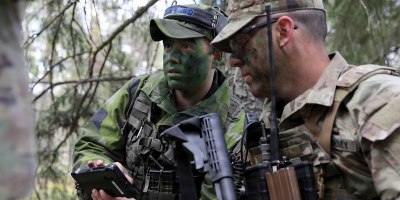 A Swedish Armed Forces service member (left) speaks with a New York Army National Guard Soldier with Troop C, 2nd Squadron, 101st Cavalry Regiment, during exercise Northern Lights 26, April 28, 2026. Northern Lights 26, also known as Aurora 26 in Sweden, is a multinational exercise involving 18,000 soldiers from 13 countries aimed at strengthening defense capabilities and enhancing interoperability with international allies. (U.S. Army photo by Master Sgt. Warren W. Wright Jr., 42nd Infantry Division public affairs)