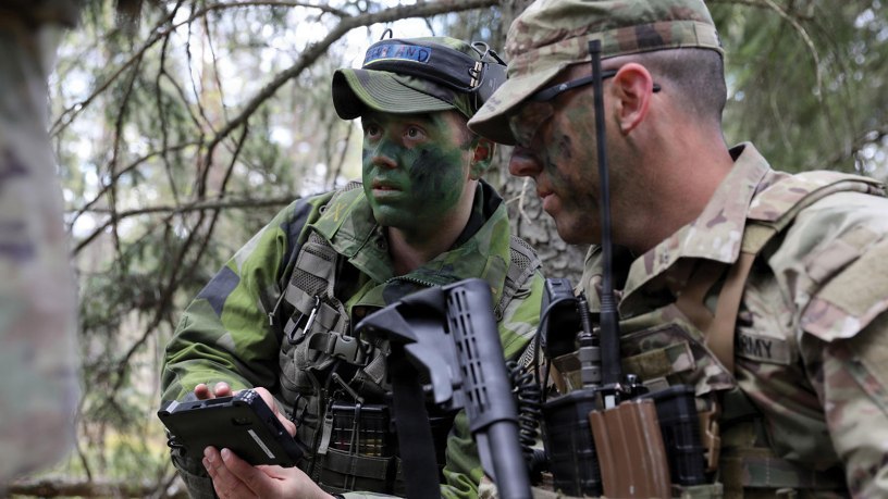 A Swedish Armed Forces service member (left) speaks with a New York Army National Guard Soldier with Troop C, 2nd Squadron, 101st Cavalry Regiment, during exercise Northern Lights 26, April 28, 2026. Northern Lights 26, also known as Aurora 26 in Sweden, is a multinational exercise involving 18,000 soldiers from 13 countries aimed at strengthening defense capabilities and enhancing interoperability with international allies. (U.S. Army photo by Master Sgt. Warren W. Wright Jr., 42nd Infantry Division public affairs)