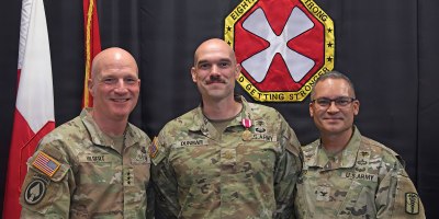 Major Michael Dunbar, 65th Medical Brigade (center), poses for a photo after being awarded the Army Meritorious Service Medal by Lt. Gen. Joe Hilbert, Eighth Army commanding general (left), for winning first place at the Fiscal Year 26 Pacific Victors Innovation Challenge. Far right is Col. Edgar Arroyo, 65th Medical Brigade commander.